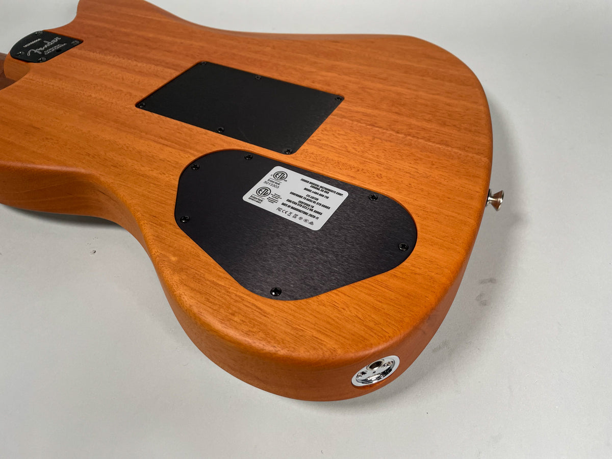 The back of the guitar shows a natural wood finish with two black control plates and a chrome output jack.