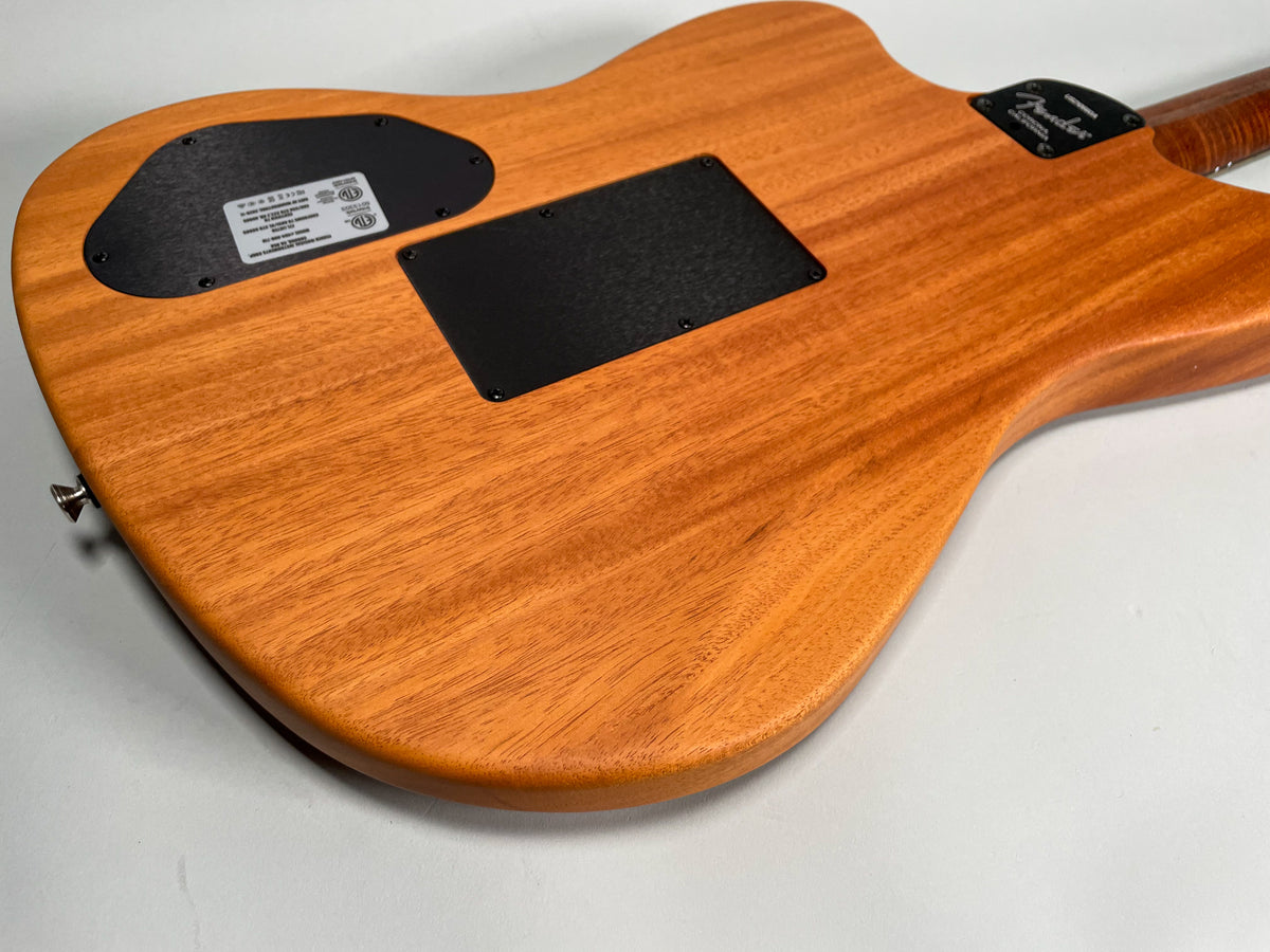 The guitar's back, a light reddish-brown wood with visible grain, features two black control plates and a chrome strap button.