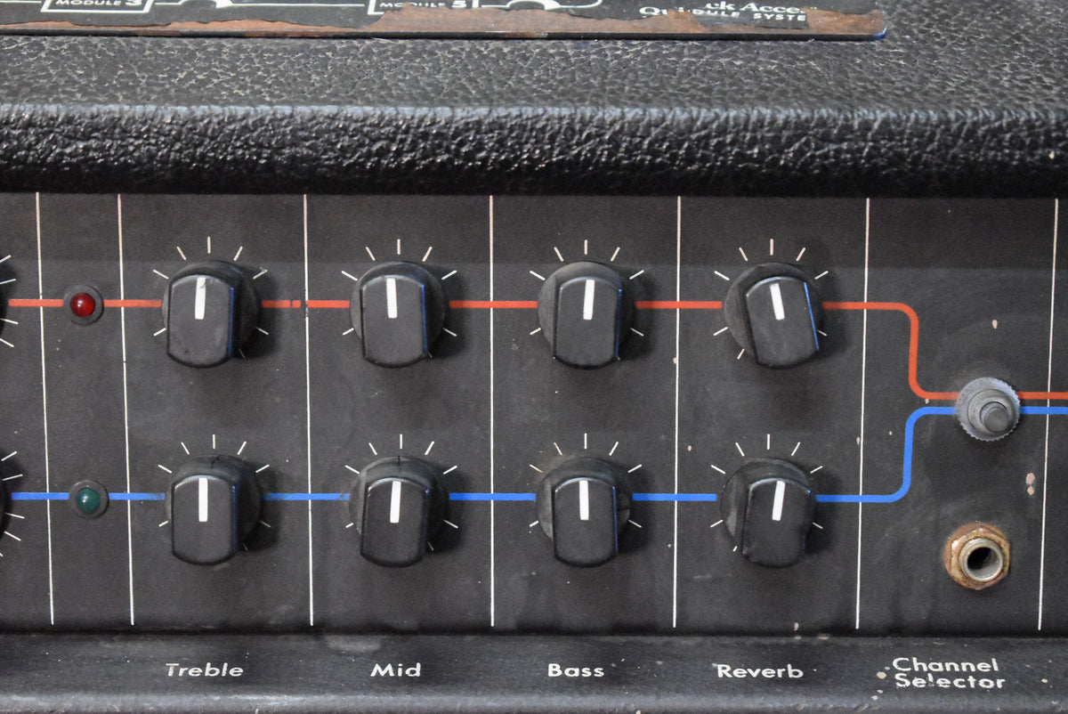 Close-up of the black control panel with eight black knobs, two indicator lights, a channel selector switch, and an input jack.