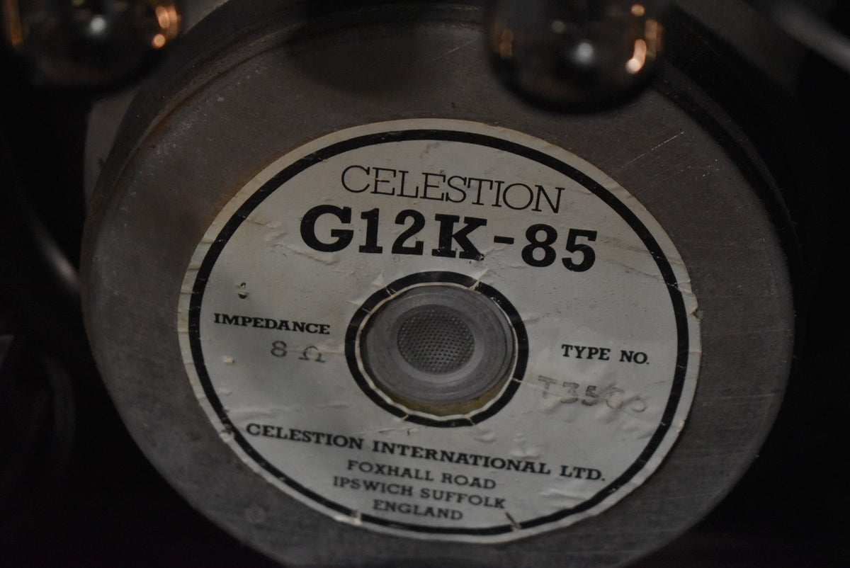 Close-up of the speaker's silver-grey magnet, with a worn white label showing "8 Ω" impedance and "T3500" type number.